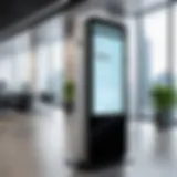 A sleek digital visitor sign-in kiosk in a modern office lobby.